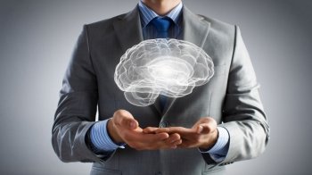 Human mind research. Close up of businessman hands holding brain in palm