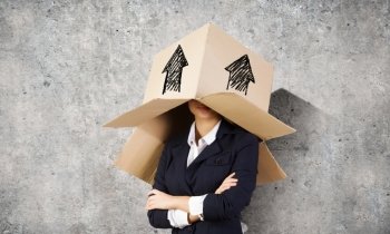 Woman with box on head. Businesswoman wearing carton box with drawings on head