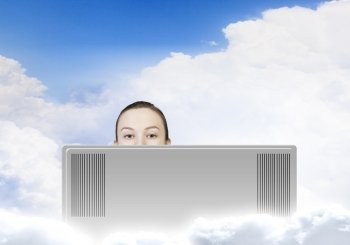 Internet addiction. Young woman looking out above laptop monitor