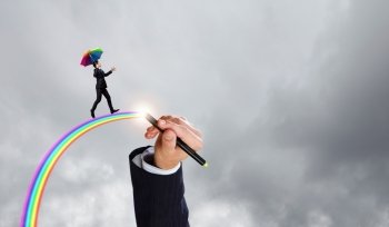 On the wave of creativity. Businessman with umbrella walking on rainbow high in sky