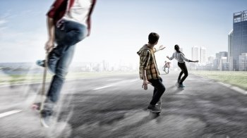 Teenagers ride skateboards. Active teenagers riding skateboard outdoor. Extreme and adrenaline