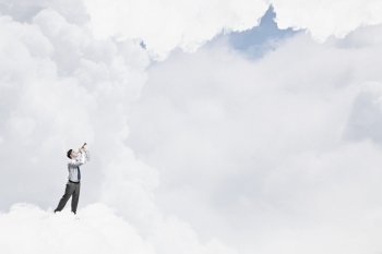 Businessman play pipe. Young businessman on cloud in sky playing pipe