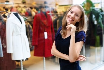 Young woman doing shopping and choosing clothes