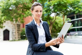 Portrait of business woman smiling outdoor. Portrait of young business woman with notebook outdoors