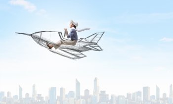 Woman in drawn airplane. Funny image of woman flying in drawn airplane