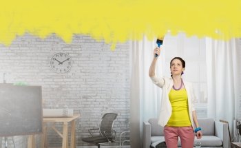 Home and house renovation mixed media. Woman with a painting roller or brush in renovate interior