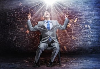 Screaming businessman. Emotional businessman sitting on chair and screaming above