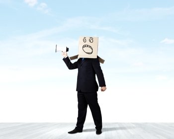 Angry businessman. Businessman wearing carton box on head and screaming in to megaphone