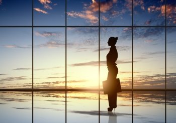 Silhouette of businesswoman. Silhouette of businesswoman against panoramic office window