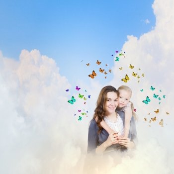 Young family. Happy mother with daughter sitting on clouds