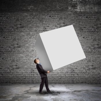 Man with cube. Young businessman carrying white blank cube. Place for text