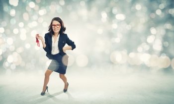 Young funny businesswoman in suit against bokeh background. Funny businesswoman