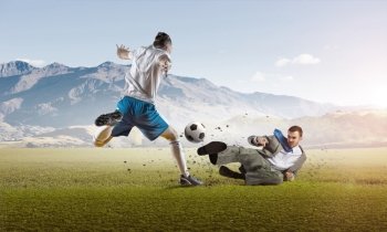 Businessman play ball. Young businessman in suit playing football with players outdoors