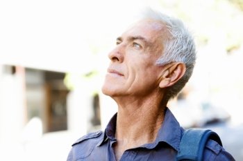 Handsome man with grey hair outdoors. Portrait of a man outdoors