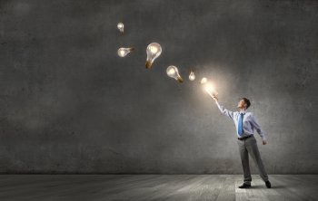 Man with opened book. Young screaming businessman on pile reaching hand with opened book and light bulb flying out 