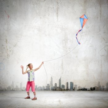 Girl with kite. Image of little girl playing with kite