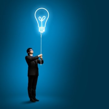 Business idea. Image of businessman with bulb balloon. Inspiration concept