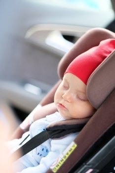 Six months old baby sleeping in car seat