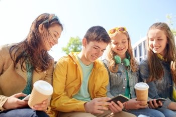 technology, internet and people concept - group of happy teenage friends with smartphone and coffee cups outdoors