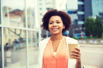 business, drinks and people concept - young smiling african american businesswoman with coffee cup in city