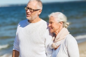 family, age, travel, tourism and people concept - happy senior couple hugging on summer beach
