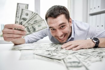 business, people, success and fortune concept - happy businessman with heap of dollar money in office
