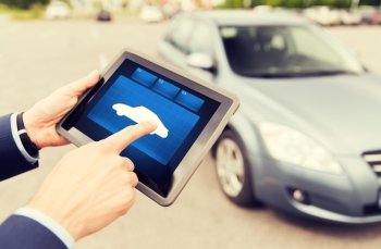 transport, business trip, technology and people concept - close up of male hands with car icon tablet pc computer screen outdoors
