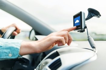 transport, business trip, technology and people concept - close up of male hand pointing to gadget screen and driving car