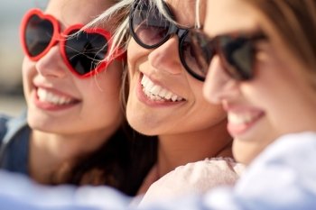 summer vacation, holidays, travel and people concept- group of smiling young women taking selfie on beach
