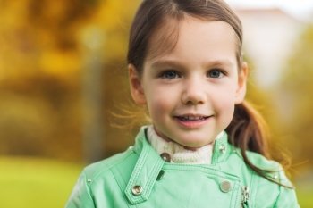 childhood, season and people concept - happy beautiful little girl portrait outdoors