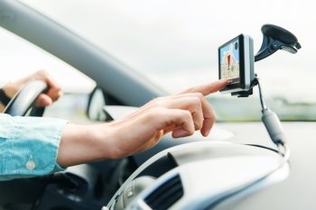 transport, business trip, technology, navigation and people concept - close up of male hand using gps navigator while driving car