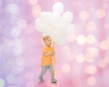 childhood, birthday, holidays and people concept - happy little baby boy with bunch of balloons over rose quartz and serenity lights background