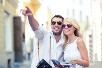 summer holidays, dating, city break and tourism concept - couple with camera and travellers guide