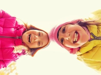 childhood, leisure, friendship and people concept - happy girls faces outdoors