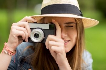 photography and people concept - close up of young woman with camera photographing outdoors. close up of woman with camera shooting outdoors