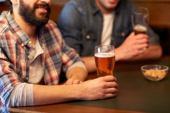 people, men, leisure, friendship and communication concept - close up of happy male friends drinking draft beer at bar or pub