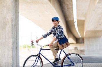 people, style, leisure and lifestyle - smiling hipster man with shoulder bag riding fixed gear bike on city street
