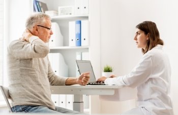 medicine, age, health care and people concept - senior man having problem with neck and doctor with laptop computer meeting in medical office at hospital