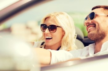 road trip, dating, leisure, couple and people concept - happy man and woman driving in cabriolet car outdoors