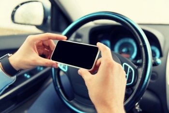 transport, business trip, technology and people concept - close up of young man hand with smartphone driving car