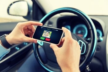 transport, business trip, communication, technology and people concept - close up of male hands with incoming video call icon on smartphone screen in car