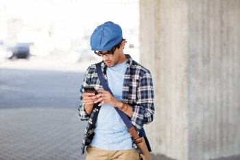 leisure, technology, communication and people concept - hipster man texting message on smartphone