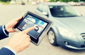 transport, business trip, mass media, technology and people concept - close up of male hands with news on tablet pc computer screen and car outdoors