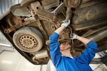 car service, repair, maintenance and people concept - auto mechanic man or smith working at workshop