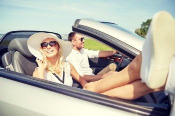 road trip, travel, dating, couple and people concept - happy man and woman driving in cabriolet car outdoors