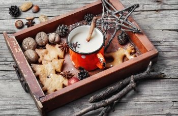 Cup of coffee and christmas symbol in wooden box. Winter cappuccino coffee in cup with star anise and christmas cookies