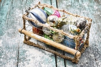 Christmas holiday decorations. Woven wire basket with vintage Christmas glass ornaments
