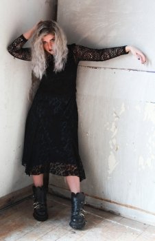 Blonde haired woman styled in a modern gothic look