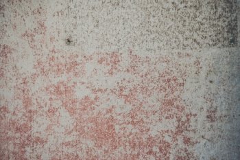 Grunge background of a concrete wall with torn red paint