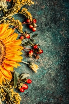 Autumn flowers setting with sunflowers  on dark rustic background, top view, border